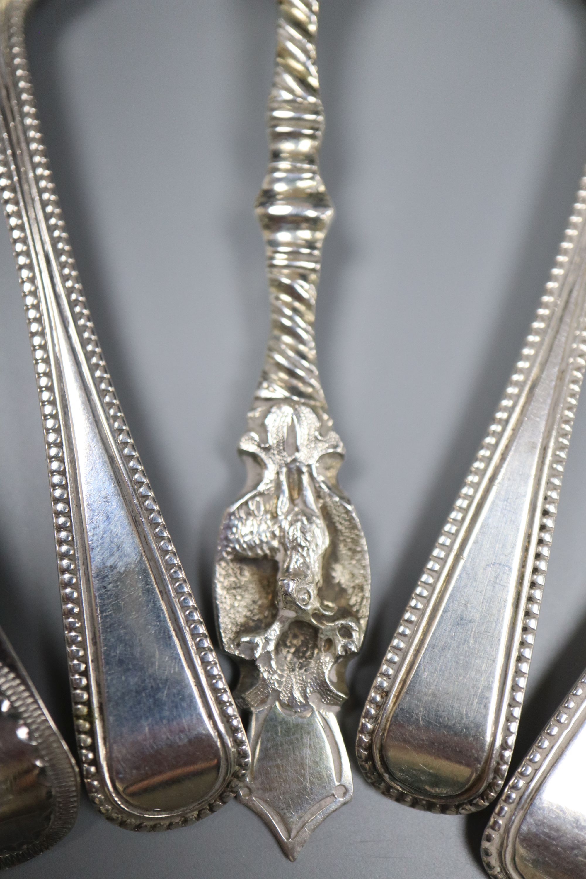 Five assorted 19th century silver condiment spoons and two white metal condiment shovels